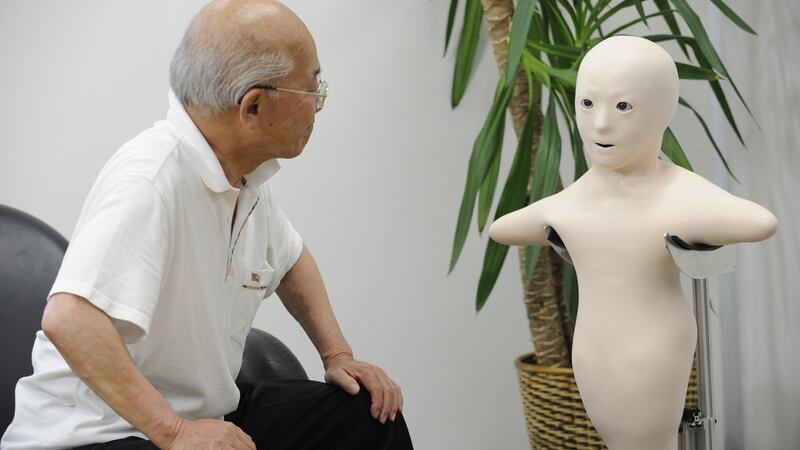 An elderly man communicates with his granddaughter via the new humanoid robot called “Telenoid R1”: Photograph: Yoshikazu Tsuno/AFP/Getty Images