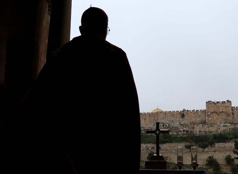 Latin Patriarch of Jerusalem, Cardinal Pierbattista Pizzaballa, leads a prayer service to mark Palm Sunday in Jerusalem, following the cancellation of the traditional Palm Sunday procession. Photograph: Ammar Awad/AFP via Getty