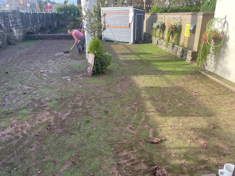 Brian Walsh clearing the beer garden at The Old Thatch in Killeagh, east Co Cork, after the floods