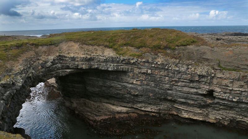 The Bridges of Ross: a single surviving sea arch looking out on the Atlantic that carved it