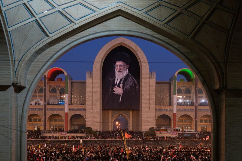 Mourners gather beneath a portrait of the late Iranian supreme leader Ayatollah Ali Khamenei during his funeral ceremony in Tehran, Iran. Photograph: Altaf Qadri/AP
