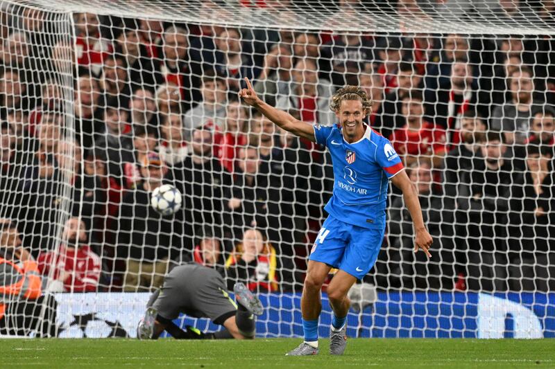 Atletico Madrid's Spanish midfielder #14 Marcos Llorente celebrates scoring his team's first goal during the UEFA Champions League first round football match between Liverpool and Atletico Madrid at Anfield in Liverpool, north west England on September 17, 2025. (Photo by Oli SCARFF / AFP) (Photo by OLI SCARFF/AFP via Getty Images)