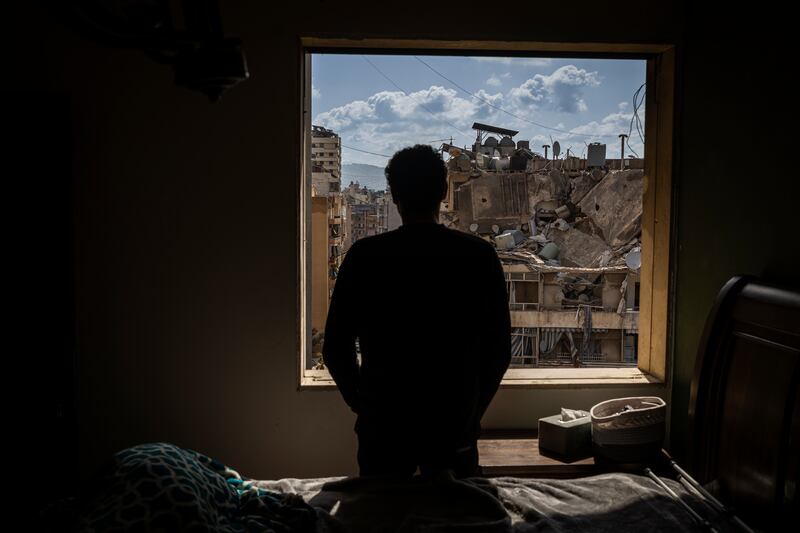 A man looks out from his apartment over the wreckage in his neighborhood near the Corniche, the seaside promenade, in Beirut, Lebanon. Photograph: Diego Ibarra Sánchez/The New York Times                    
