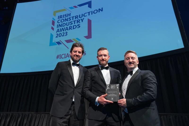 Aaron Murphy, contracts director at Globoserv, presents the design project of the year award to Paul Connolly and Kevin Bates, Scott Tallon Walker Architects