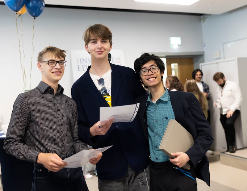 (LtoR) Alexey Golovanov, Alexey Flippov and Phong Le look at each others papers after receiving their Leaving Cert results, which were announced on Friday, photographed at the Institute of Education, Dublin. Photograph: Sam Boal/Collins Photos.