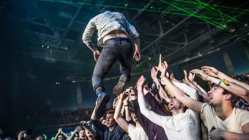 Yannis Philippakis dives into the crowd during  Foals’ concert in the 3Arena in Dublin. Photograph: Ruth Medjber