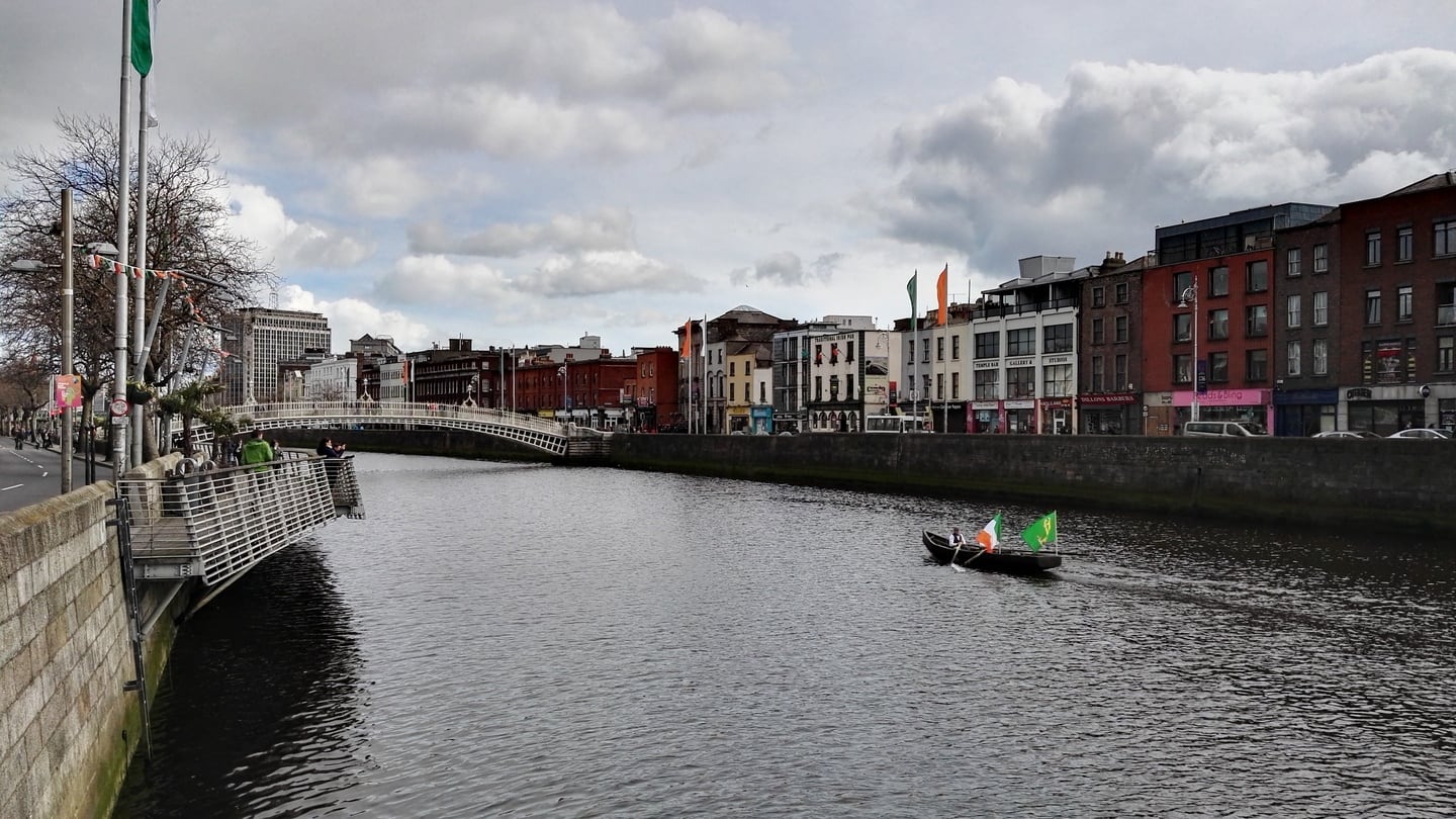 Two men in period costumes rowed this boat up the River Liffey at lunchtime on Easter Monday, with the Tricolour and the Plough and the Stars on display. Photograph: Peter Smyth/The Irish Times