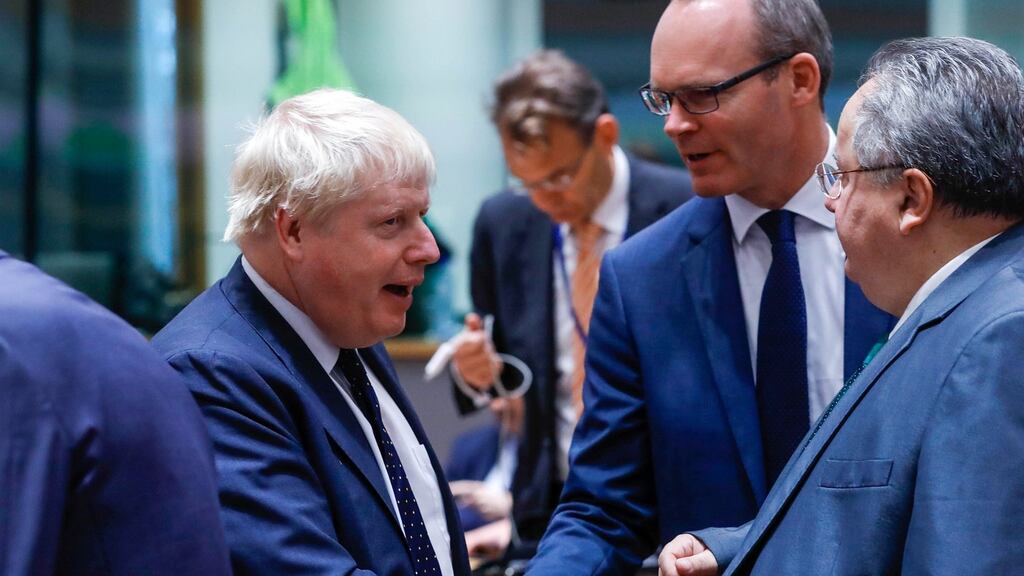 Minister for Foreign Affairs Simon Coveney shakes hands with Britain’s foreign secretary Boris Johnson following a European Union foreign ministers’ meeting in Brussels. Photograph: Yves Herman/Reuters