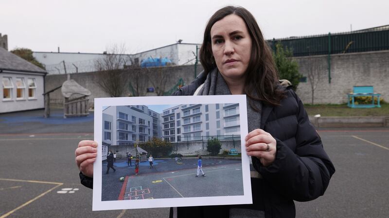 Principal Naomi Rousseau holds a computer-generated image of the proposed   apartment block overlooking the school playground. Photograph: Laura Hutton