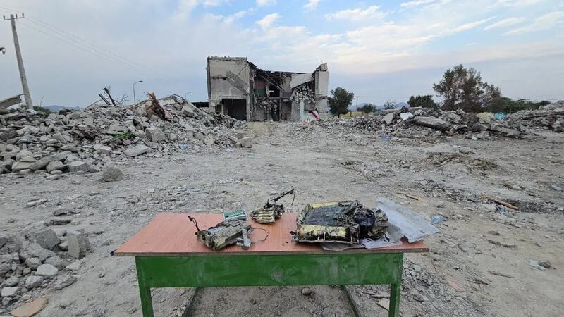 A government handout photograph showed weapon remnants displayed on a table near the ruins of the Shajarah Tayyebeh elementary school, where a precision strike killed 175 people, mostly children, on February 28th. 