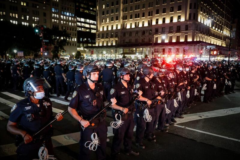 New York police on Fifth Avenue after curfew on Thursday. Photograph: John Minchillo/AP