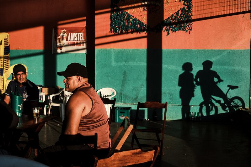 Men drink beer in a public market in Cruzeiro neighbourhood in Brasília. Photograph: Gustavo Minas