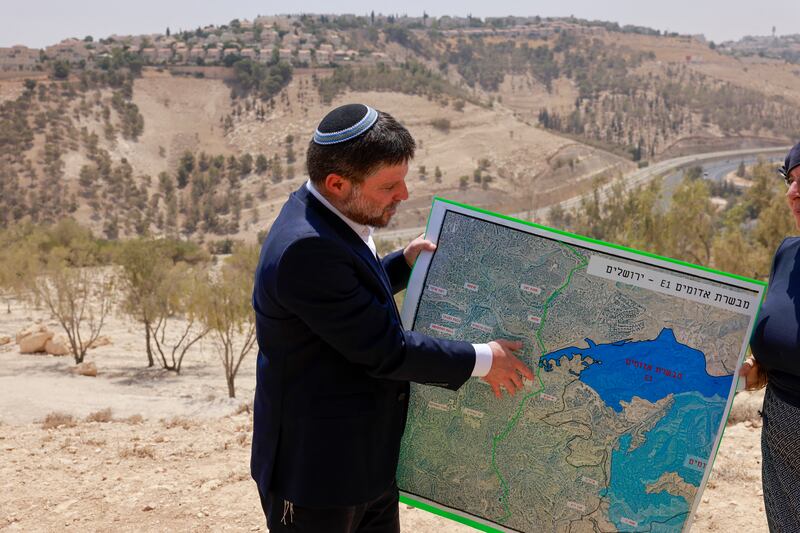 Israeli far-right finance minister Bezalel Smotrich displays a map of an area near the settlement of Ma'ale Adumim, a land corridor known as E1, outside Jerusalem in the occupied West Bank, in recent days. Photograph: Menahem Kahana/AFP/Getty