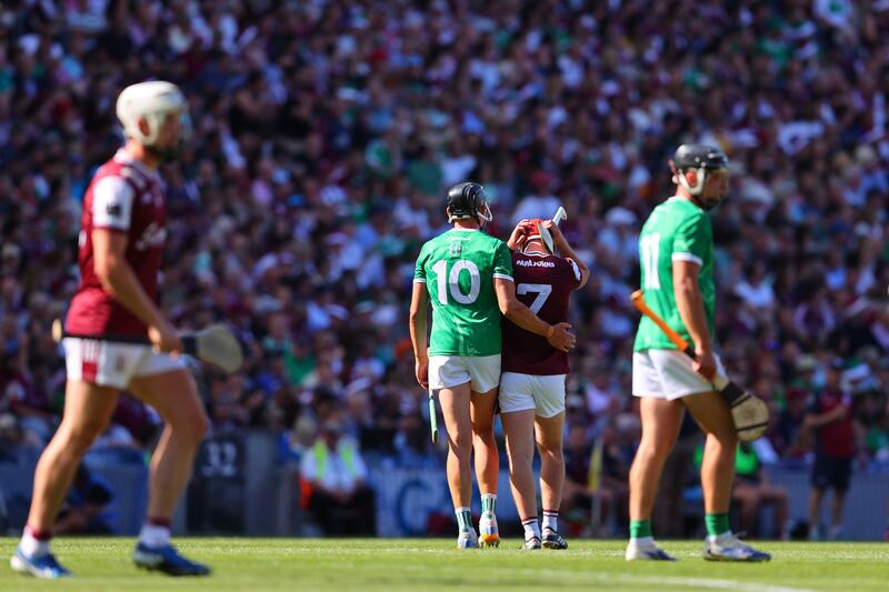 Limerick's Gearoid Hegarty consoles Galway's Ronan Glennon as he leaves the field after receiving a red card. Photograph: Tom O’Hanlon/Inpho