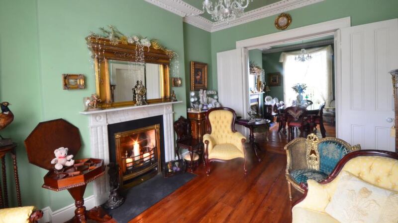 The two interconnecting reception rooms at hall level at 22 Howth Road are packed with period furniture.