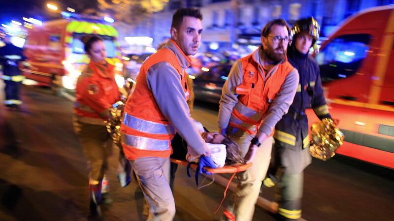 A woman is  evacuated from the Bataclan theatre. Photograph: Thibault Camus/AP Photo