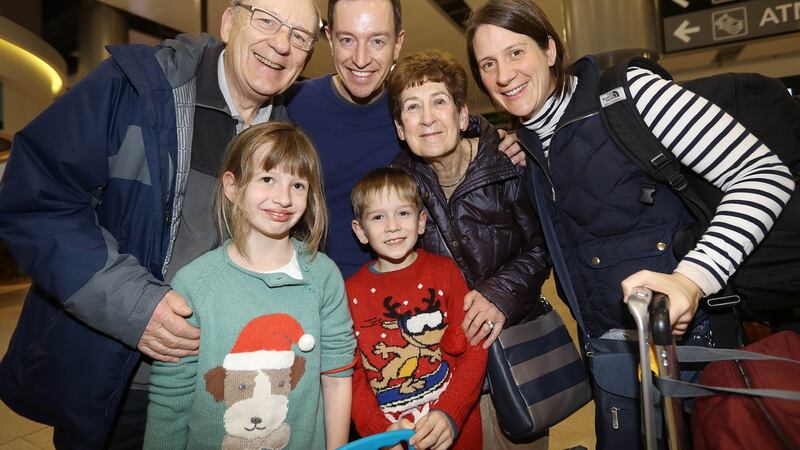 Alan and Heather Hill from Belfast welcome home their daughter Ruth, son in law Jason Prince and grandchildren Fiona and Ronan from Boise, Idaho at Dublin Airport. Photograph: Lorraine O’Sullivan/The Irish Times