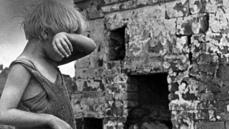 An orphan cries outside the family home in Byelorussia, destroyed by Germans, during the second World War. Photograph: Michael Trakhman/Slava Katamidze Collection/Getty Images