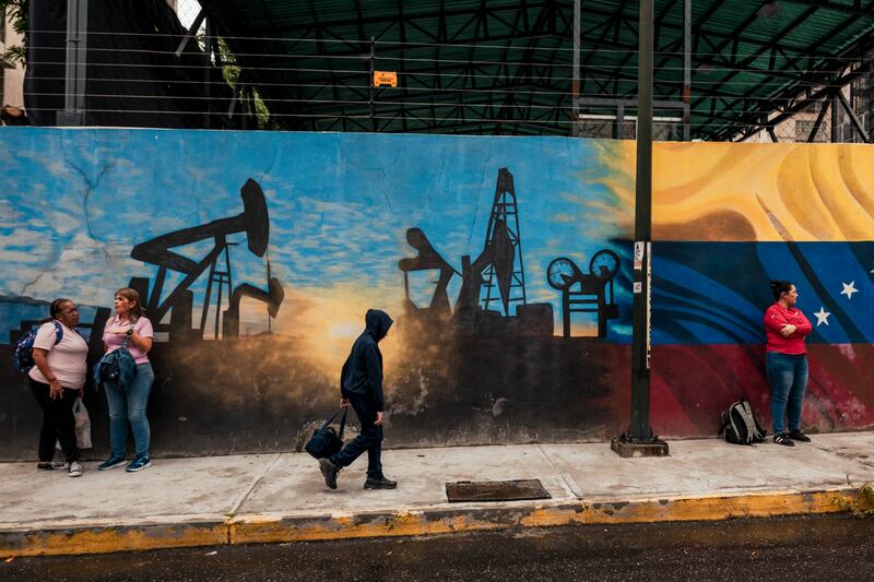 People outside the state oil company Petróleos de Venezuela’s headquarters in Caracas. Photograph: Adriana Loureiro Fernandez/New York Times             