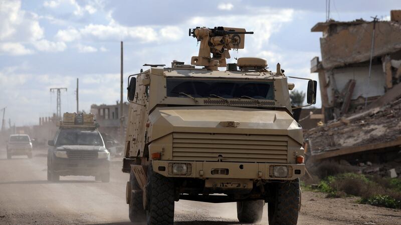 A heavily armoured troop carrier in transit in the village of Baghouz, Deir Al Zor province, Syria. Photograph: Reuters