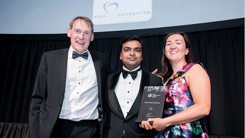 Rohit Garg, Managing Partner, Axon Outsourcing, presents the Finance Team of the Year award to Mark O'Connor & Rose O’Sullivan, Fexco.