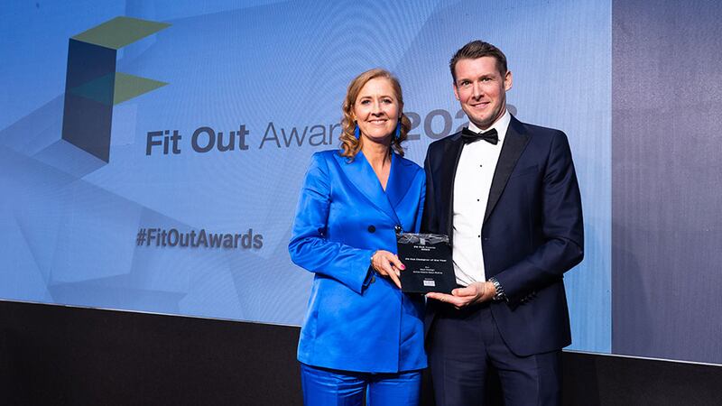 Robbie Hamilton, director at CRM, presents the fit out designer of the year award to Anne-Marie Saul-Rotne, Saul Design