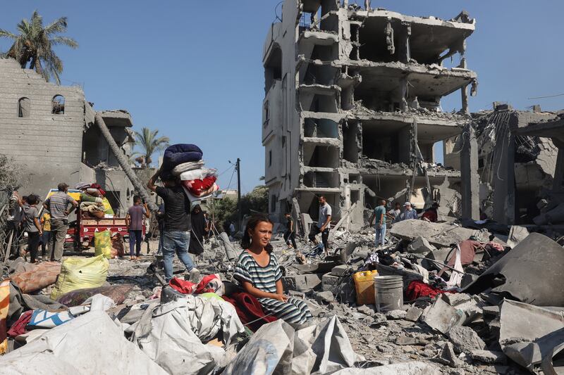A Palestinian girl sits as people recover belongings in Deir el-balah in the central Gaza Strip, on August 7th, following Israeli bombardment. Photograph: Eyad Baba/AFP via Getty