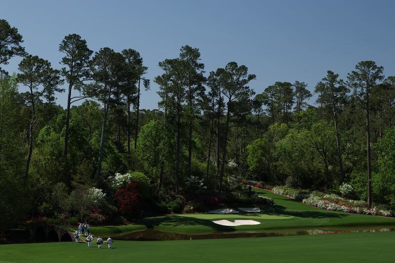 Fred Couples, Brooks Koepka, Justin Thomas and Adam Scott stand on the Hogan Bridge at the 12th hole during a practice round prior to the 2025 Masters Tournament at Augusta. Photograph: Richard Heathcote/Getty Images