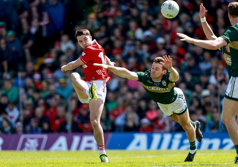 Cork's Chris 0g Jones kicks Kerry's Gavin White attempts to block in the Munster football final. Photograph: INPHO/Dan Sheridan