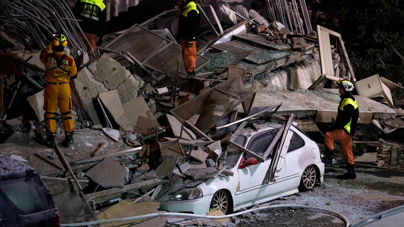 Rescue services search for people in a damaged building in Hualien, eastern Taiwan. Photograph:  EPA/RITCHIE B. TONGO