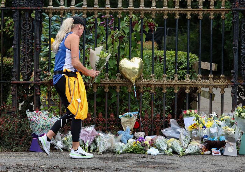 People place flowers at the entrance to the scene in Donabate, Co Dublin, where gardai discovered remains presumed to be those of Daniel Aruebose. Photograph: Colin Keegan/ Collins