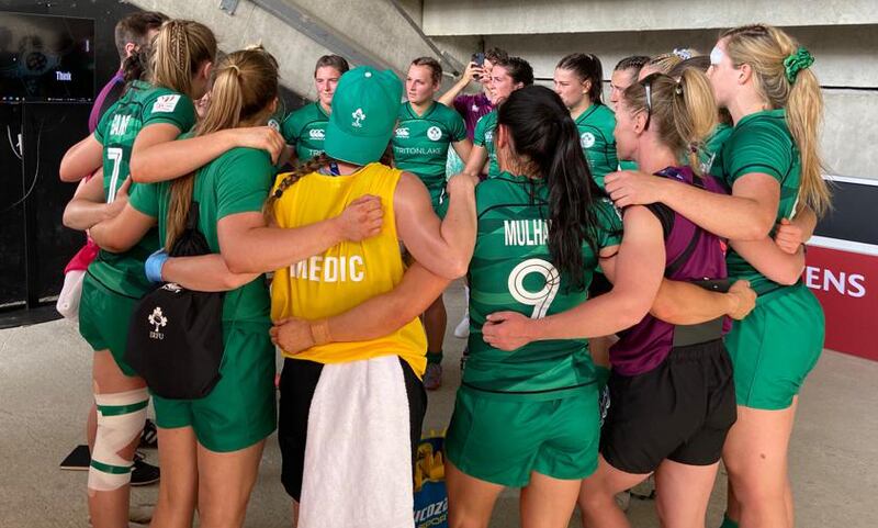 The Ireland Women’s team seek shelter under the stand for their post-match debrief. Photograph: John O'Sullivan/The Irish Times