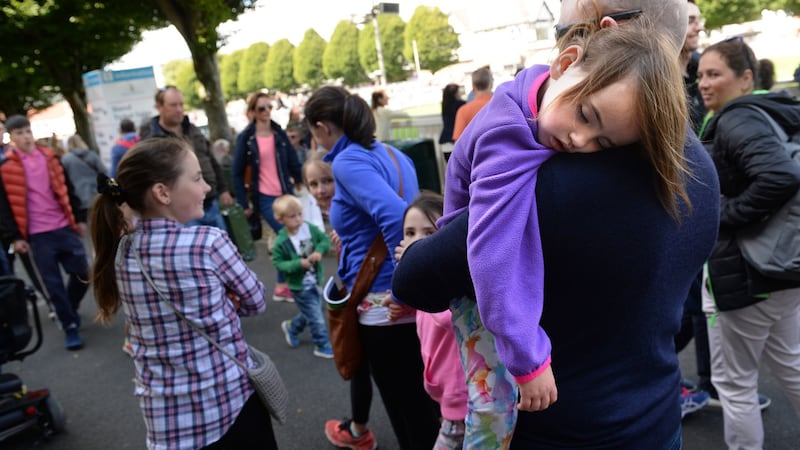 Maria Flemming Hand sleeps on her father Mark Hand’s shoulder at the Dublin Horse Show. Photograph: Dara Mac Dónaill