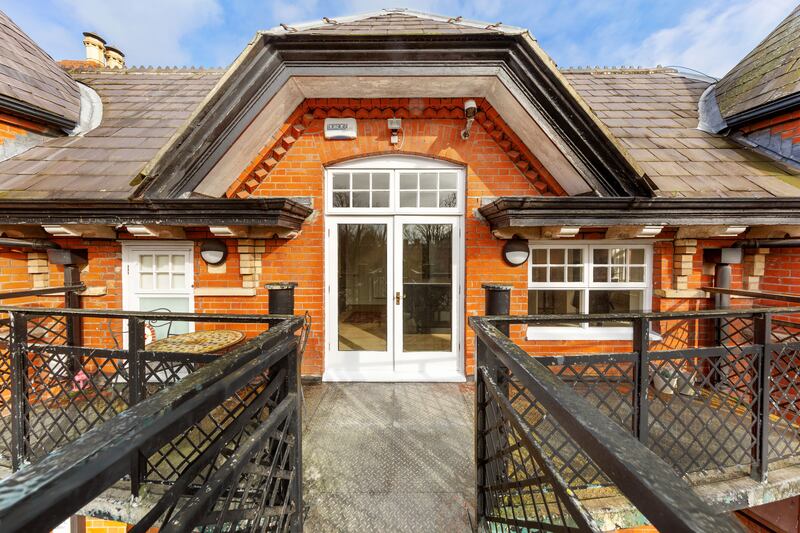 A private balcony off the kitchen overlooks the garden