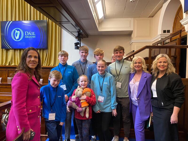 The McGrath family on budget day: Sarah McGrath with the couple’s seven children, and Fianna Fáil TD Niamh Smyth and FF Senator Lorraine Clifford-Lee
