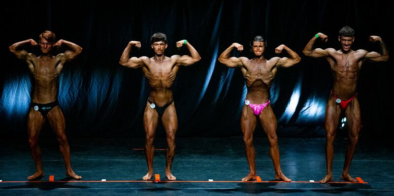 Competitors in the Junior Men's Bodybuilding contest perform the double-bicep pose. Photograph: Tom Honan 