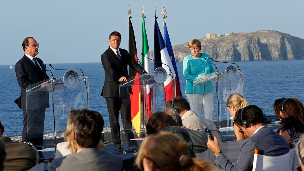 Italian prime minister Matteo Renzi (centre) with Angela Merkel and François Hollande talk of EU co-operation on the aircraft carrier Garibaldi. Photograph: Remo Casilli/Reuters