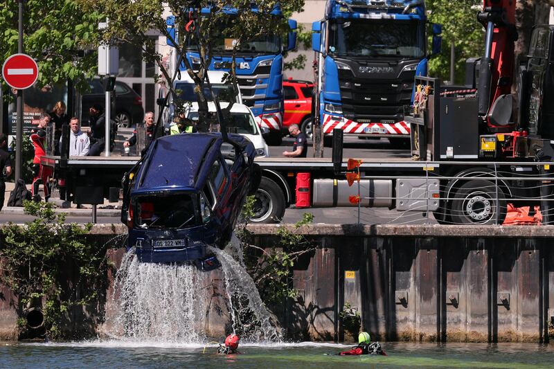 Rescue teams remove the car from the Seine. Photograph: Thomas Samson/AFP/Getty
