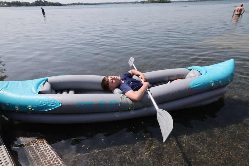 Boy takes a break from an inflatable kayak on Lough Owel in Westmeath. Photograph: Alan Betson / The Irish Times

