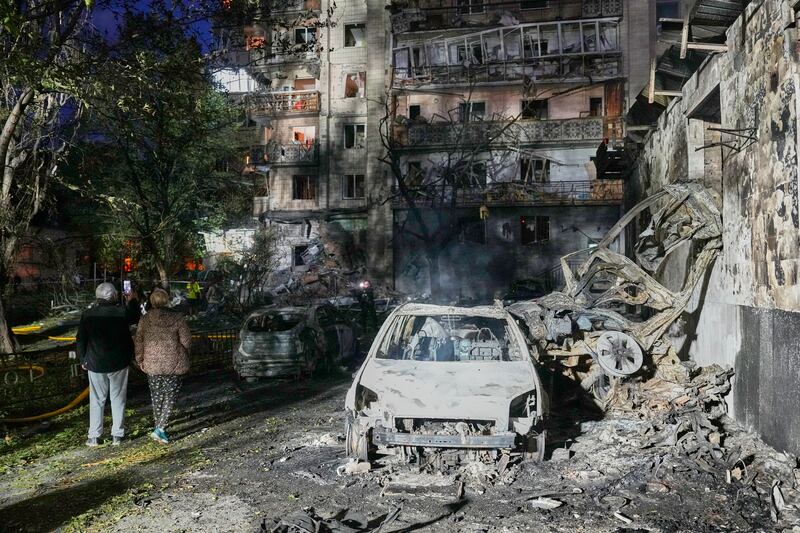 Local residents walk among debris following Russia’s missile attack on Kyiv. Photograph: Efrem Lukatsky/AP