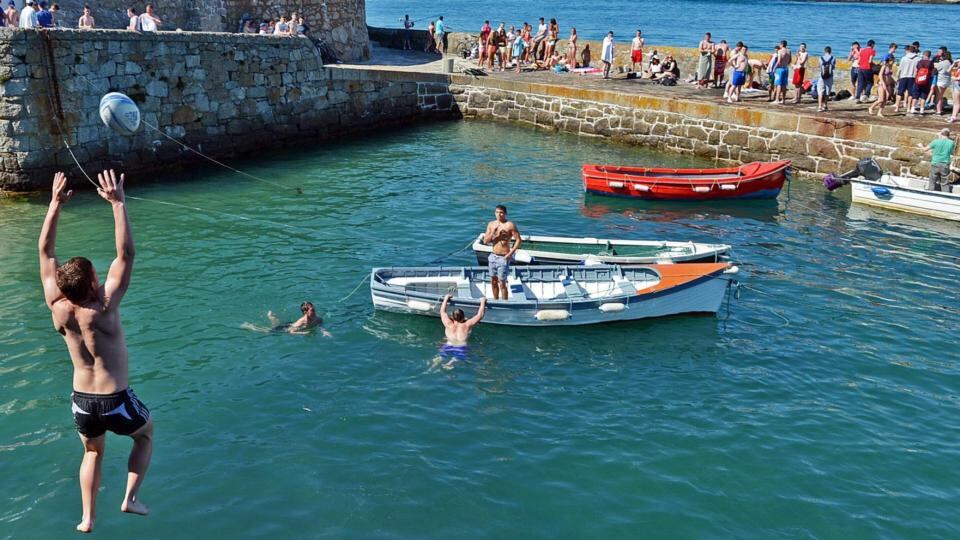 As temperatures rise to record levels, people take to the water to cool down, at Coliemore Harbour, Dalkey, Co. Dublin, yesterday. Photograph: Eric Luke / The Irish Times