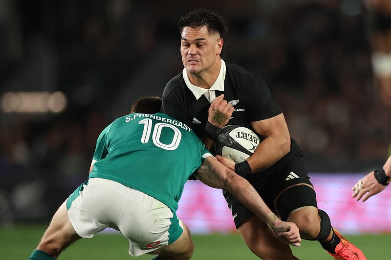 New Zealand's Quinn Tupaea is tackled by Ireland's Sam Prendergast. Photograph: Phil Walter/Getty Images