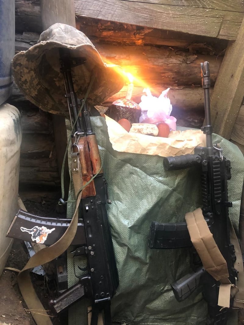An Easter celebration in a drone pilot's dugout, with a lit candle in a paska cake