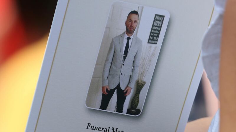 A woman holds the mass booklet at the funeral of Bobby Messett. Photograph:  Colin Keegan/Collins