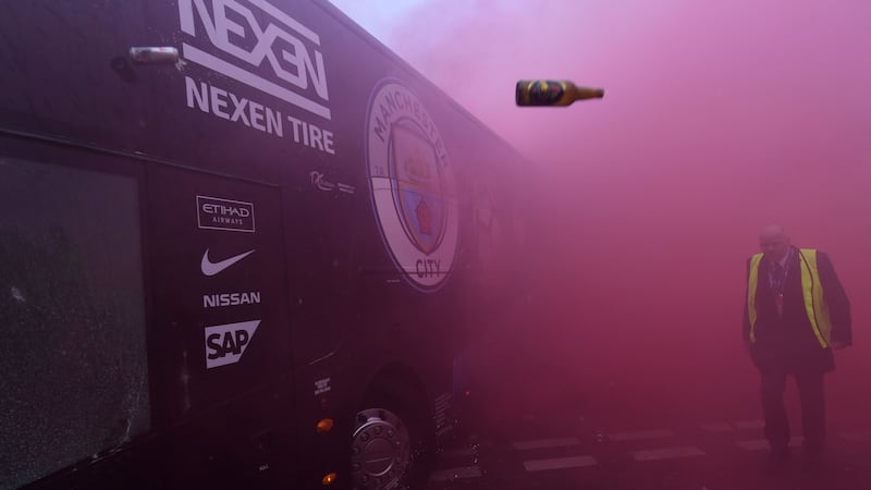 Bottles and cans are thrown at the bus as Manchester City players arrive at Anfield for  Uefa Champions League tie. Photograph: Getty Images