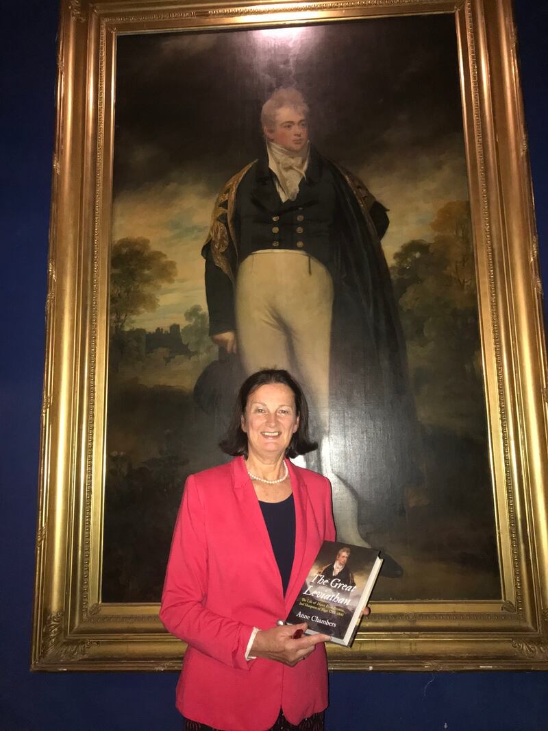 Anne Chambers with her biography of Lord Sligo  in front of his portrait in Westport House