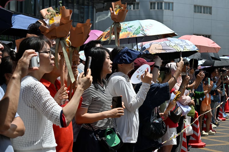 Parents wait for their children during the first day of China's "gaokao", outside a high school in Beijing. Photo: Adek Berry/AFP