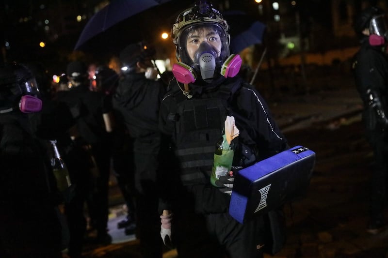 Pro-democracy protesters in action outside the Polytechnic University.  Photograph: Fazry Ismail/EPA