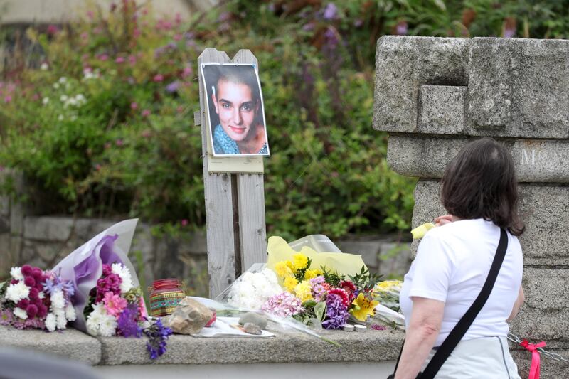 27/07/2023 A photo of Sinead O'Connor with flowers and messages left outside Sinead O'Connor’s former house in Bray seafront this afternoon.
Pic Colins Keegan/Collins Photos