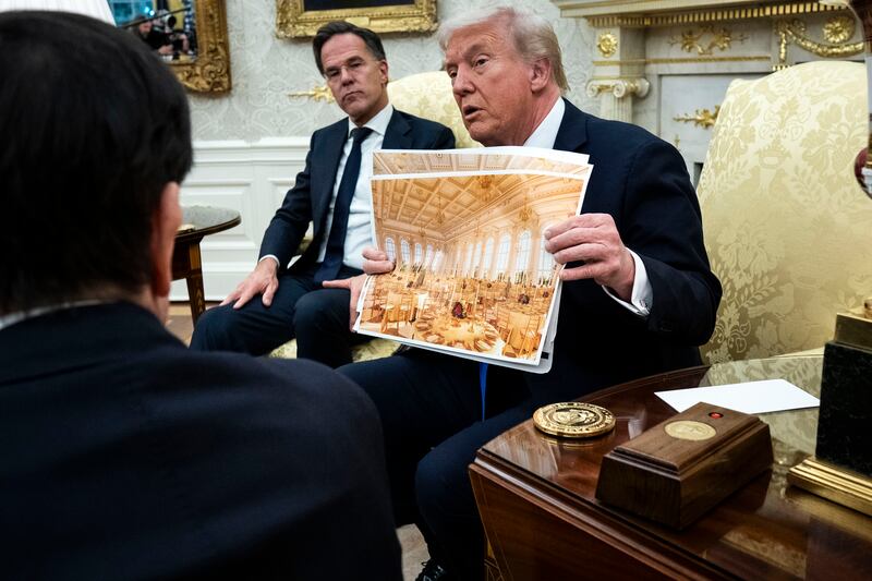 Donald Trump holds a rendering of the new White House ballroom. Photograph: Doug Mills/The New York Times